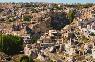 Wonderful panoramic view of ancient Ortahisar cave city. Blue sky background. Popular travel destination in Turkey. UNESCO World Heritage Site. Autumn sunny day panorama