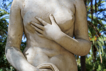 Detail of hands and chest of a statue of a sensual Renaissance woman.