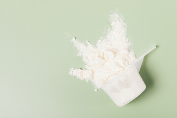 Whey protein powder sports nutrition scattered from measuring