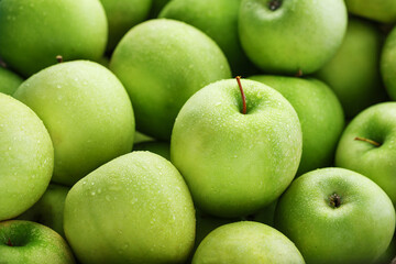 Juicy Green apple close-up with dew drops.