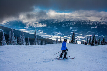 Revelstoke Mountain Resort, British Columbia Canada, male skier gets superb views of Columbia River...