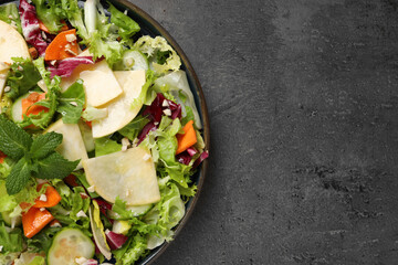 Delicious turnip salad served on grey table, top view. Space for text