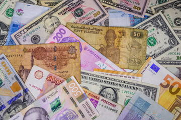 Fototapeta na wymiar Multi currency background. Euro, american dollars, ukrainian hryvnias, egyptian pounds, russian roubles
