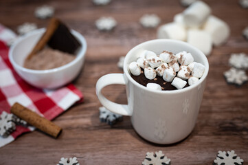 Cup of chocolate wit marshmallow on a wooden table