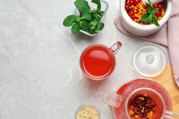 Flat lay composition with immunity boosting drink on light grey marble table. Space for text