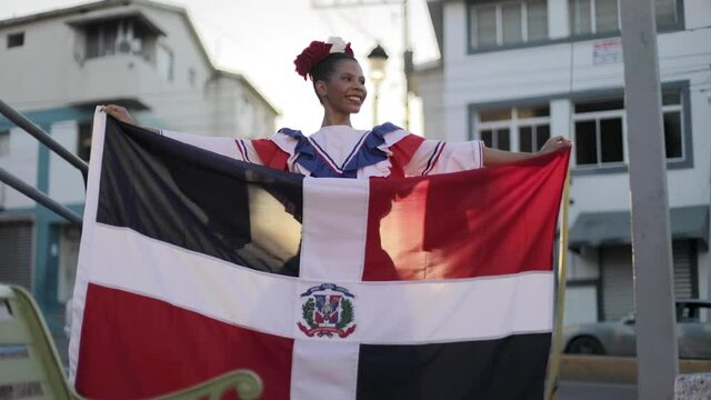 dominican girl holding a dominican flag