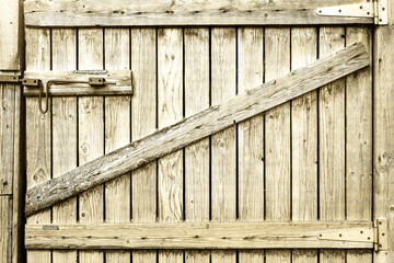 Wooden door to the barn or horse stall, lock on the door.