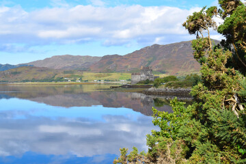 Fototapeta na wymiar Reflection of a distant castle in a Scottish lake, UK