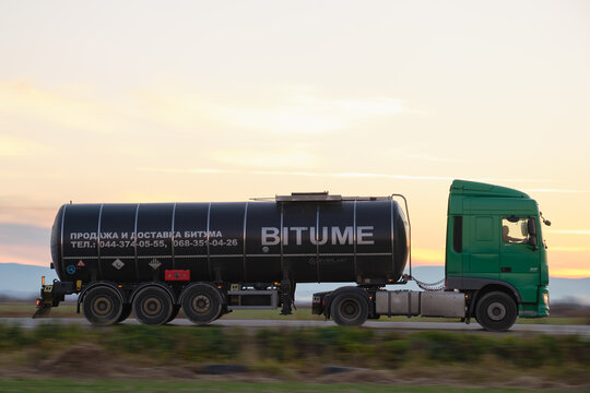 Petrol cargo truck driving on highway hauling oil products. Delivery transportation and logistics concept. Kyiv, Ukraine - October 12, 2021.