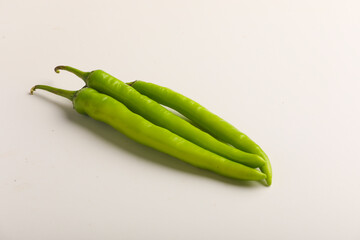 Fresh green chilli on white background.