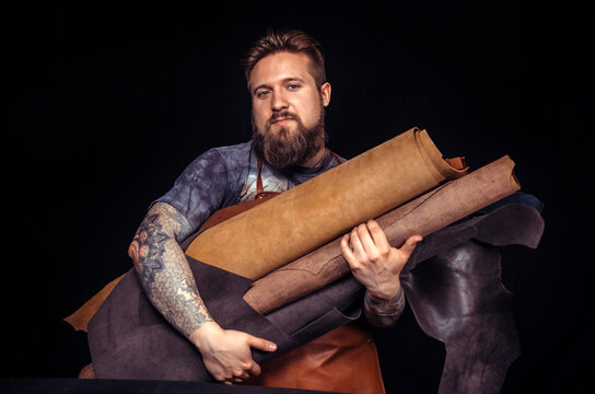 Man working with leather creates quality product of leather at the shop