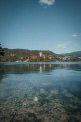 landscape on a lake surrounded by mountains and houses