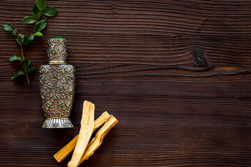 Agar wood tree oil perfume in silver bottle with sticks of tree