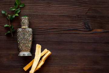 Foto op Plexiglas Agar wood tree oil perfume in silver bottle with sticks of tree © 9dreamstudio