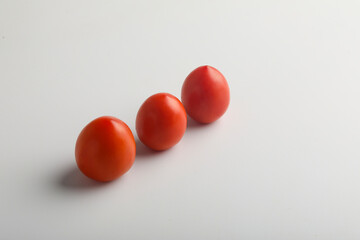 Fresh red tomato on white background.