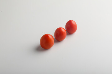 Fresh red tomato on white background.