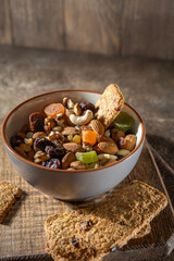 Nuts and dried fruits, oat biscuits in bowl, products for boost immunity system, vertical, selective focus