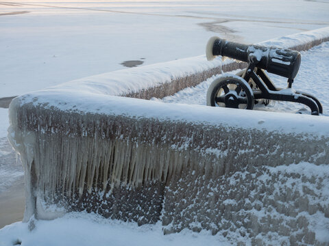 Metal  cannon sculptures covered with ice due to a winter storm on the embankment of the city of Petrozavodsk in the Republic of Karelia on a frosty day