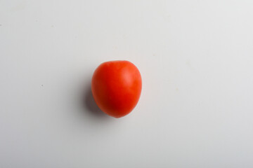 Fresh red tomato on white background.