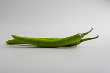 Fresh green chilli on white background.