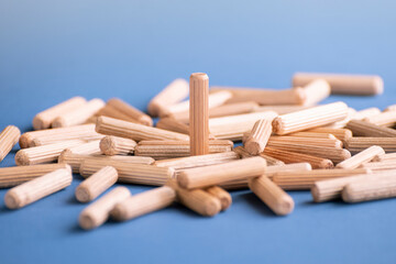Various fasteners for furniture assembly on blue background. Furniture fittings.