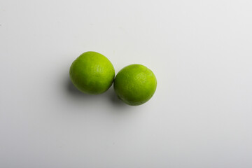 Fresh green lemon on white background.