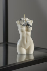 White candle in the shape of a womans body