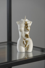 White candle in the shape of a womans body
