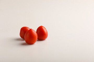 Fresh red tomato on white background.