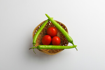 Fresh Green chilli and tomatos on white background.