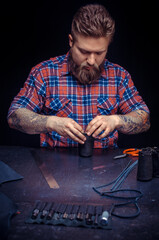 Leather Tanner working with leatherwork at the tanning shop