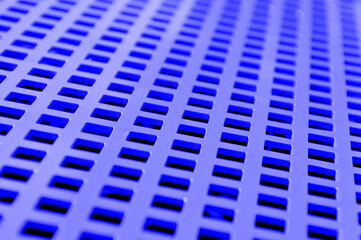 pattern background formed by a painted and perforated metal plate, selective focus