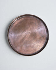 New luxury cutlery view from above on a isolated white background. Top view. Copper saucer. Trendy plate pastel shades. Flat lay view.