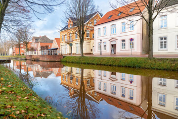 View of pastel colored houses along the canal in Papenburg, Germany