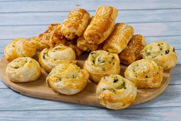 Pies and buns on a wooden table. Fresh pastries are prepared at home. A delicious crispy appetizers. close up