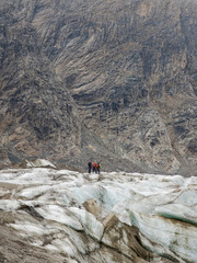 Climbers hiking on Glacier Pasterze at Mount Grossglockner, which is melting extremely fast due to global warming. Europe, Austria, Carinthia