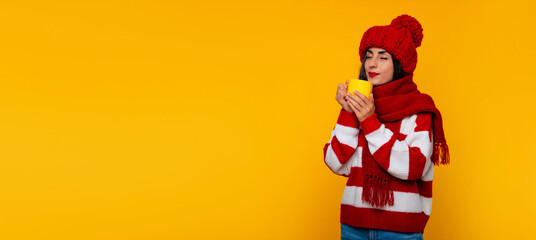 Banner photo of cute stylish tender woman in red winter clothes holds beverage in yellow cup in hands and dreaming