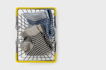 socks in shopping cart isolated on white