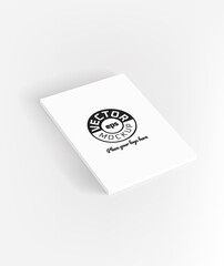 Book with white cover lying on a table. Vector mockup. Place your logo or any content