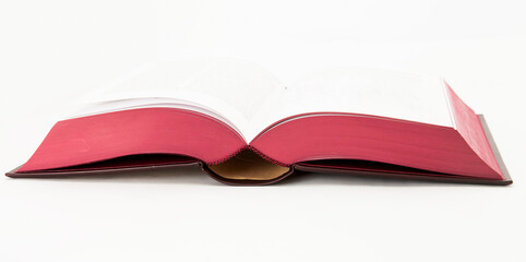 Isolated opened book with red pages isolated on white
