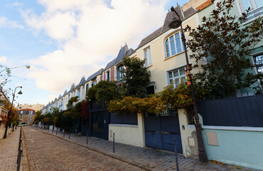 Fototapeta na wymiar Colorful houses at Dieulafoy street in the 13th District is one of the prettiest residential streets in Paris. France.