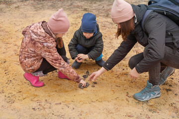 Children explore rocks and minerals in the sand