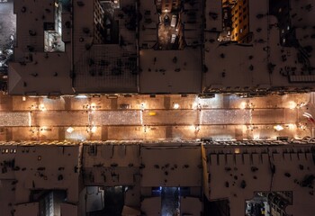 Aerial winter cityscape of Lodz, Poland.  View along the famous tourist attraction - Piotrkowska Street with rooftops covered in snow. © uslatar