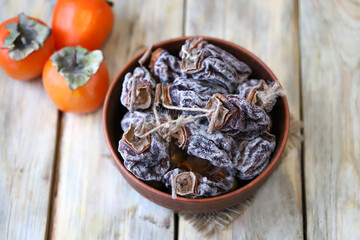 Selective focus. Dried persimmon in a bowl.