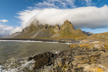 Europe, Iceland. Clouds drape the mountains of Eystrahorn on the south coast.