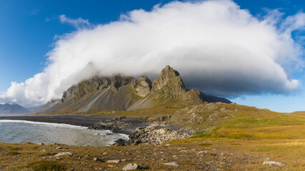 Europe, Iceland. Clouds drape the mountains of Eystrahorn on the south coast.