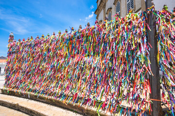 View of some bands attached to the gates of the Church of Our Lord of Bonfim written "Souvenir from Bahia" and "Our Lord of Bonfim of Bahia" - Salvador, Bahia, Brazil