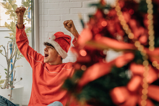 Excited Teenager Boy At Home On Christmas