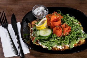 Salmon salad on a black bowl full of tasty.