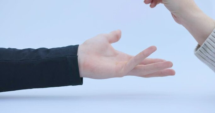 Crypto's, cryptocoins, Bitcoin or BTC,being dropped in a man's hand, depicting earning or paying with crypto or cryptocurrency and saving, holding or hodling. High quality 4k footage